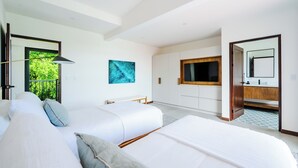 A modern hotel room with two beds, a large window, a painting, a bathroom with a mirror, and a view of greenery outside. - Elegant Modern Villa with Private Pool & Rooftop, Near Beach and City Center (Tamarindo)