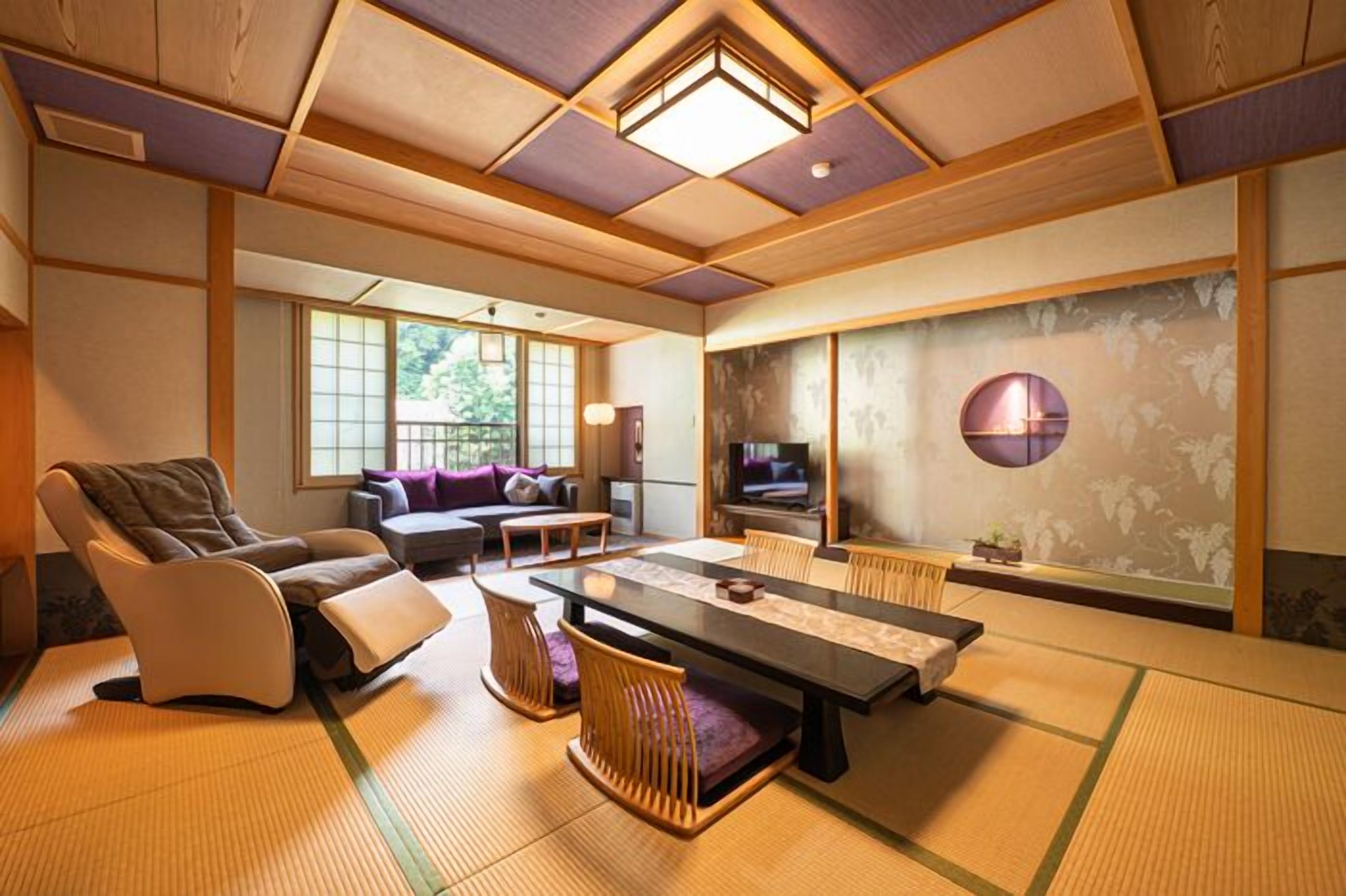 A traditional Japanese-style room with tatami flooring, a low table, and a sofa.