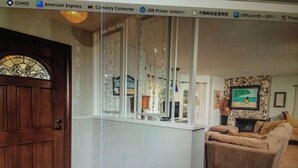 A living room with a brown door, a white wall, and a brown sofa. - 50 ft from the SAND 30 seconds (Del Mar)