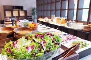 A buffet with various food items including a large salad bowl, bowls of fruit, and other dishes. - nol hakone myojindai (Hakone)