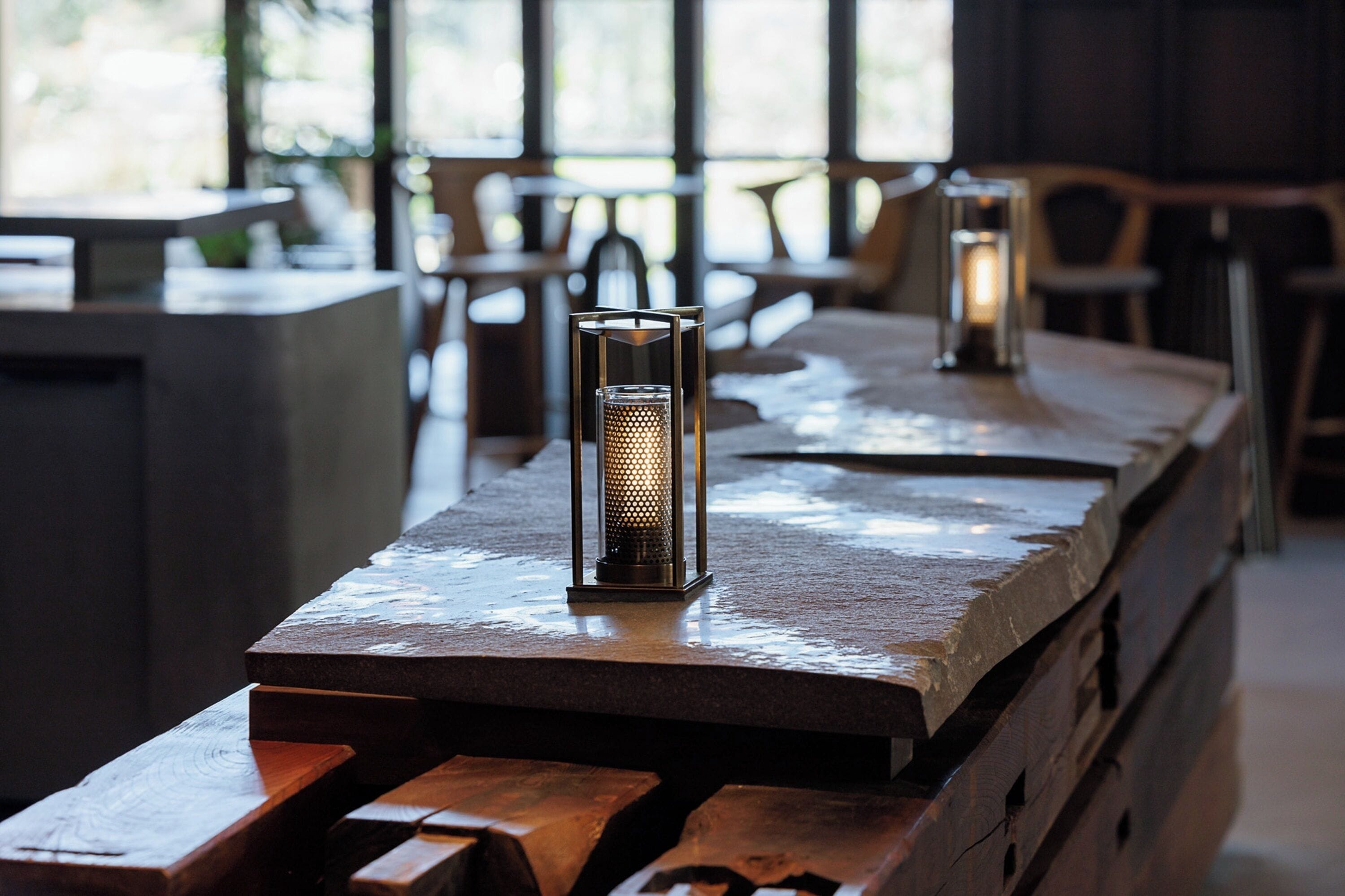 A bar area with a wooden counter and a candle holder.