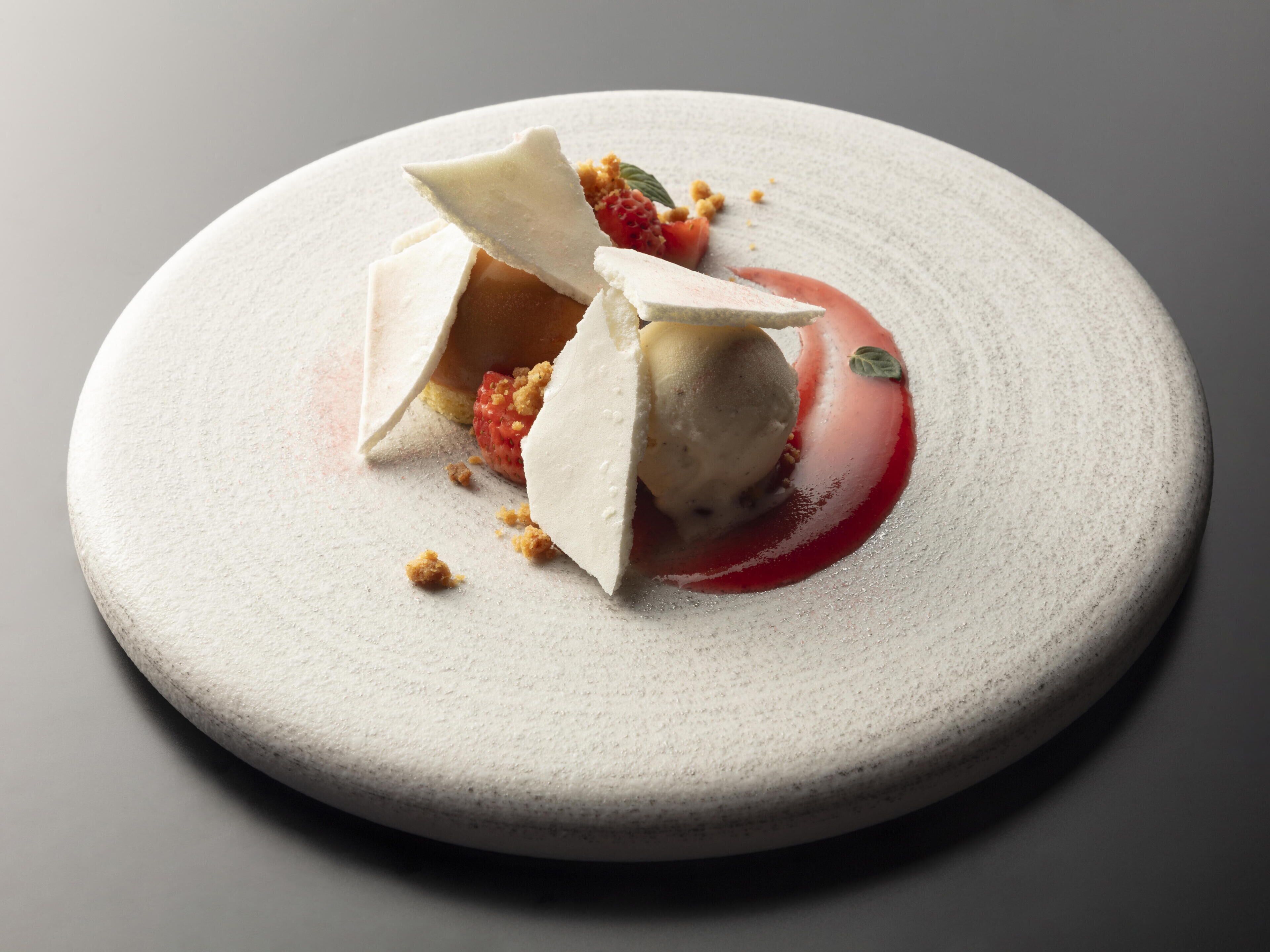 A dessert on a round plate with a textured surface.