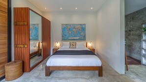 A bedroom with a large bed, wooden headboard, a world map on the wall, and two bedside lamps. - Villa Jungalow 2BR Pool Villa Near Beach Café del Mar & Padel (Canggu)
