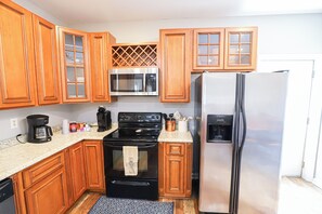 Enjoy cooking in this well-equipped kitchen with a stove, refrigerator, and microwave.