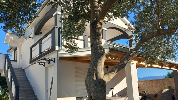 A modern two-story house with a staircase, outdoor seating area, and a pergola. - Apartment with a pool, mountainview, near the sea! (POSEDARJE)