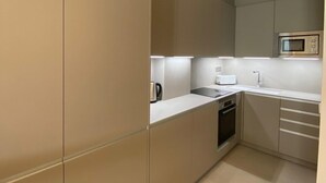 A modern kitchen with a built-in oven, a microwave, and a toaster.