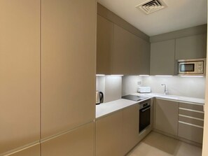 A modern kitchen with a built-in oven, a microwave, and a toaster. - Sitges Spaces Garden Oasis, Near Beach, Renovated (Sitges)