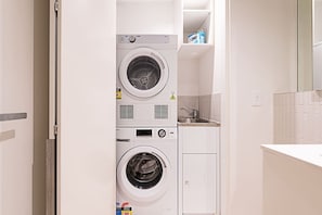 Convenient laundry facilities with two front-loading washing machines.
