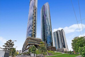 Stunning high-rise building with a unique curved facade and balconies.
