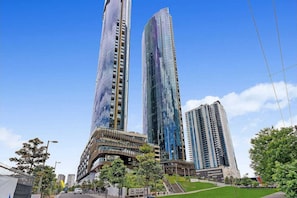 Stunning high-rise building with a unique curved facade and balconies.
