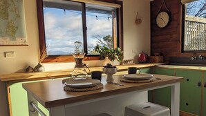 A kitchen with a wooden countertop, a sink, and a window with a view of the sky. - Sun-drenched with spectacular views. Central location for exploring Bruny. (Alonnah)