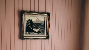 A bed with pillows and a framed picture on the wall. - Sun-drenched with spectacular views. Central location for exploring Bruny. (Alonnah)