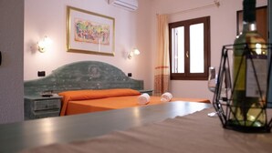 A bedroom with a bed, a nightstand, a wall-mounted light, a window with curtains, and a framed picture. - Idyllic Residence Cala Viola Studio sleeps num1373 (Sos Alinos)