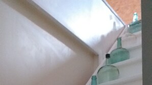A staircase with multiple steps, each holding a glass bottle.
