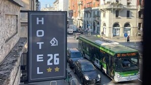 A hotel sign with the number 26 and a star rating. - Hotel 26 (Milan)