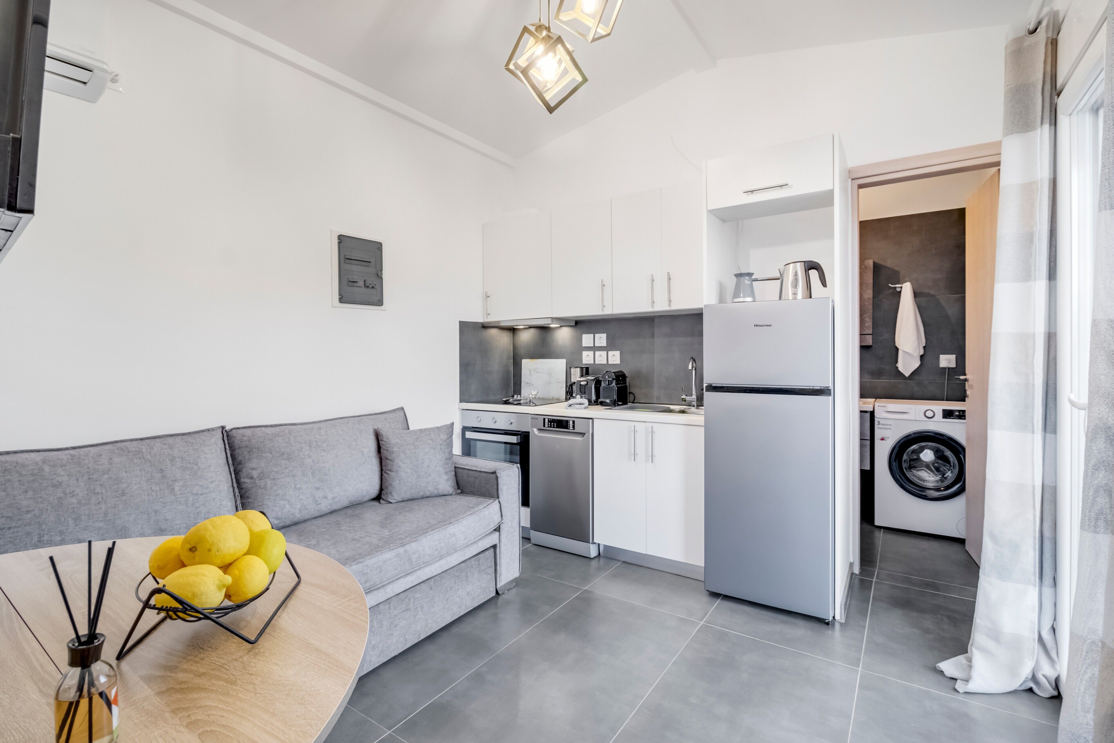 A modern kitchen with white cabinets, a built-in oven, and a dishwasher.