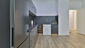 A modern kitchen with grey cabinets, a built-in dishwasher, and wooden flooring. - Big Family Suite with 7 beds in the center of Göppingen (Göppingen)