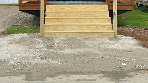 A wooden cabin with a porch, a window, and a door. - Family + Pet-Friendly Cabin w/ Loft | Surf City (Holly Ridge)