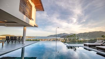 Outdoor pool, a heated pool, open open 24 hours a day, pool umbrellas