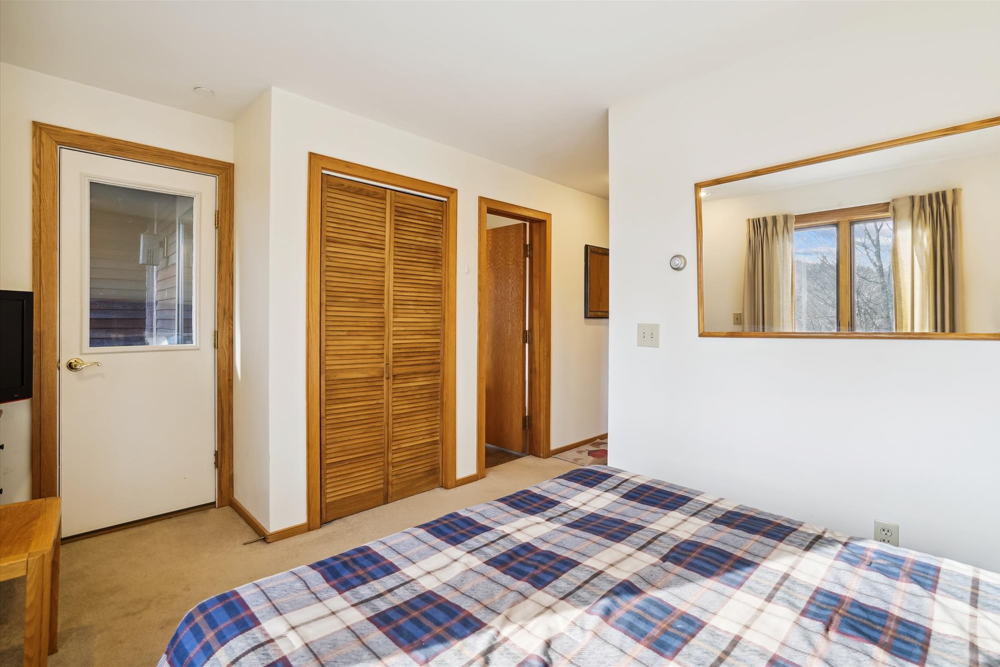 Easy In and Out - This bedroom offers convenient access to the hallway and nearby living spaces.