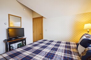 Everything You Need to Unwind - With a TV, bedside lighting, and closet space, this bedroom is ready for a comfortable stay.