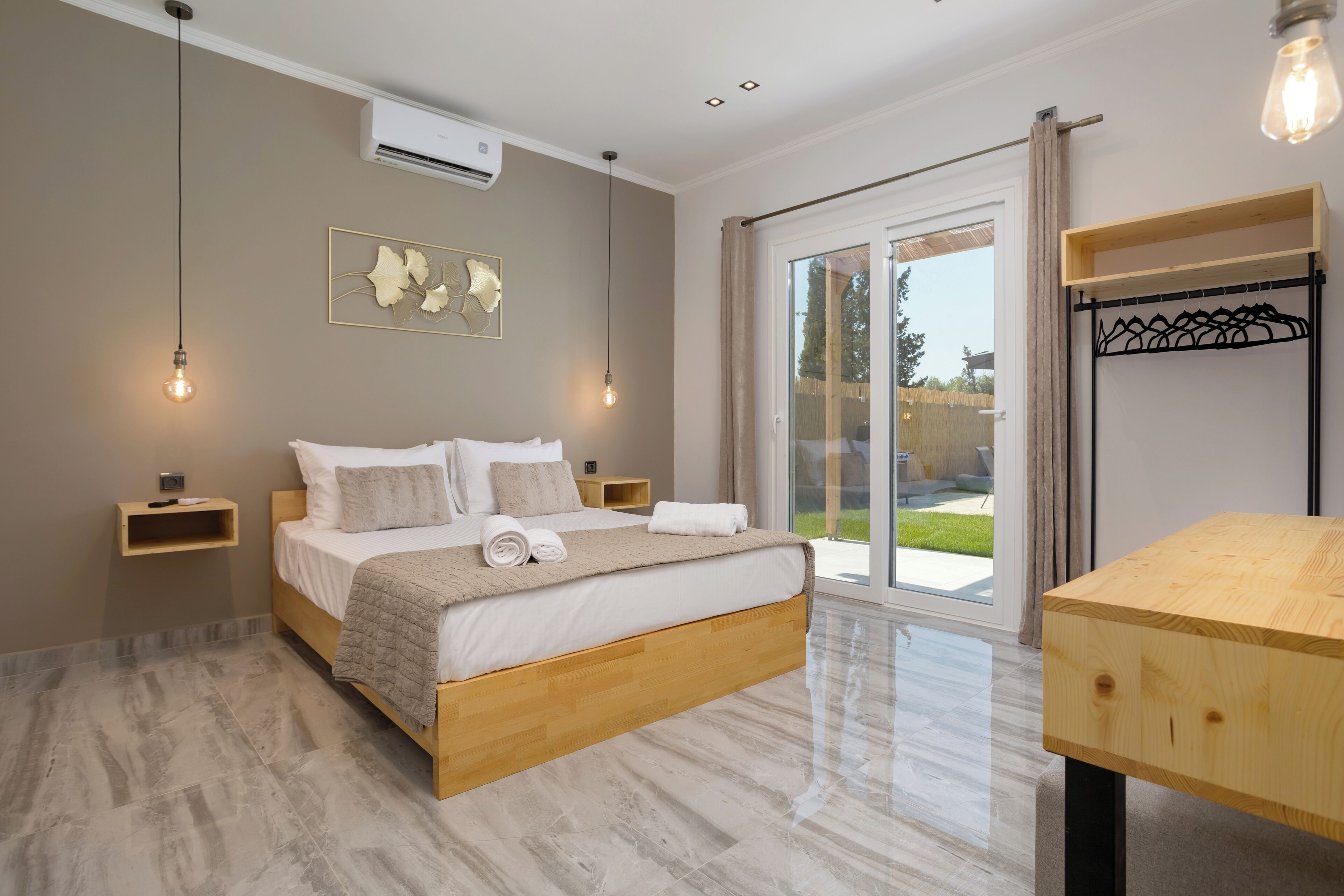 A modern bedroom with a wooden bed, a large window, and a wooden table.