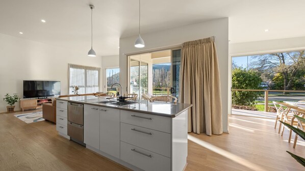 Enjoy meals in the spacious kitchen with a large island and dining area overlooking a scenic view.