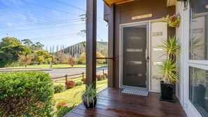 Step into Nannia & Poppy's Place, where a charming entrance welcomes you to a serene retreat.