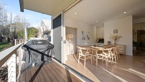 Enjoy meals on the balcony or in the dining area with a wooden table and chairs.