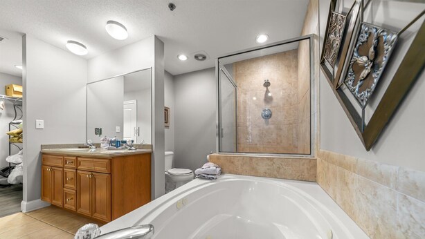 Ein modernes Badezimmer mit einer großzügigen Badewanne, einer Dusche und einem Waschbecken mit Spiegel.