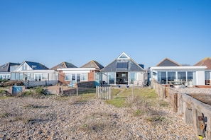 Houses with large windows and pitched roofs, set in a, secure environment.