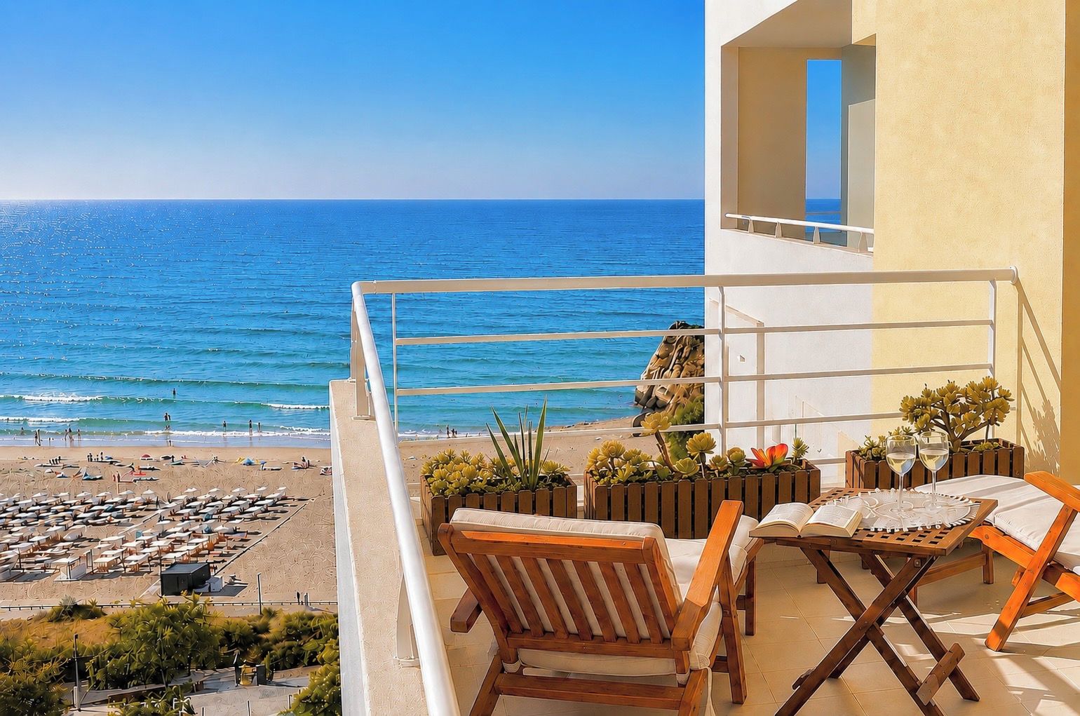 A balcony with a view of the sea, wooden furniture, and potted plants.