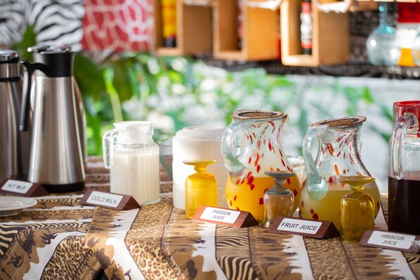A variety of beverage containers on a table with labels indicating different types of juices. - Jet Villas Entebbe (Entebbe)
