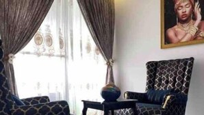 Ein Zimmer mit einem gemusterten Sessel, einem passenden Sofa und einem Tisch mit einer dekorativen Schale.
