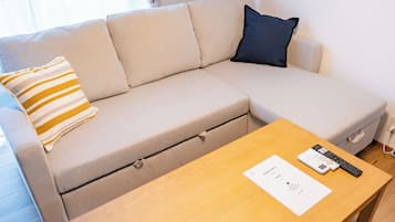 Basic Quadruple Room | Living area | 32-inch Smart TV with digital channels, Netflix, Hulu