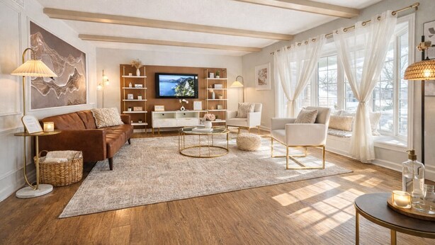A spacious living room with a large TV, comfortable seating, and a bookshelf.