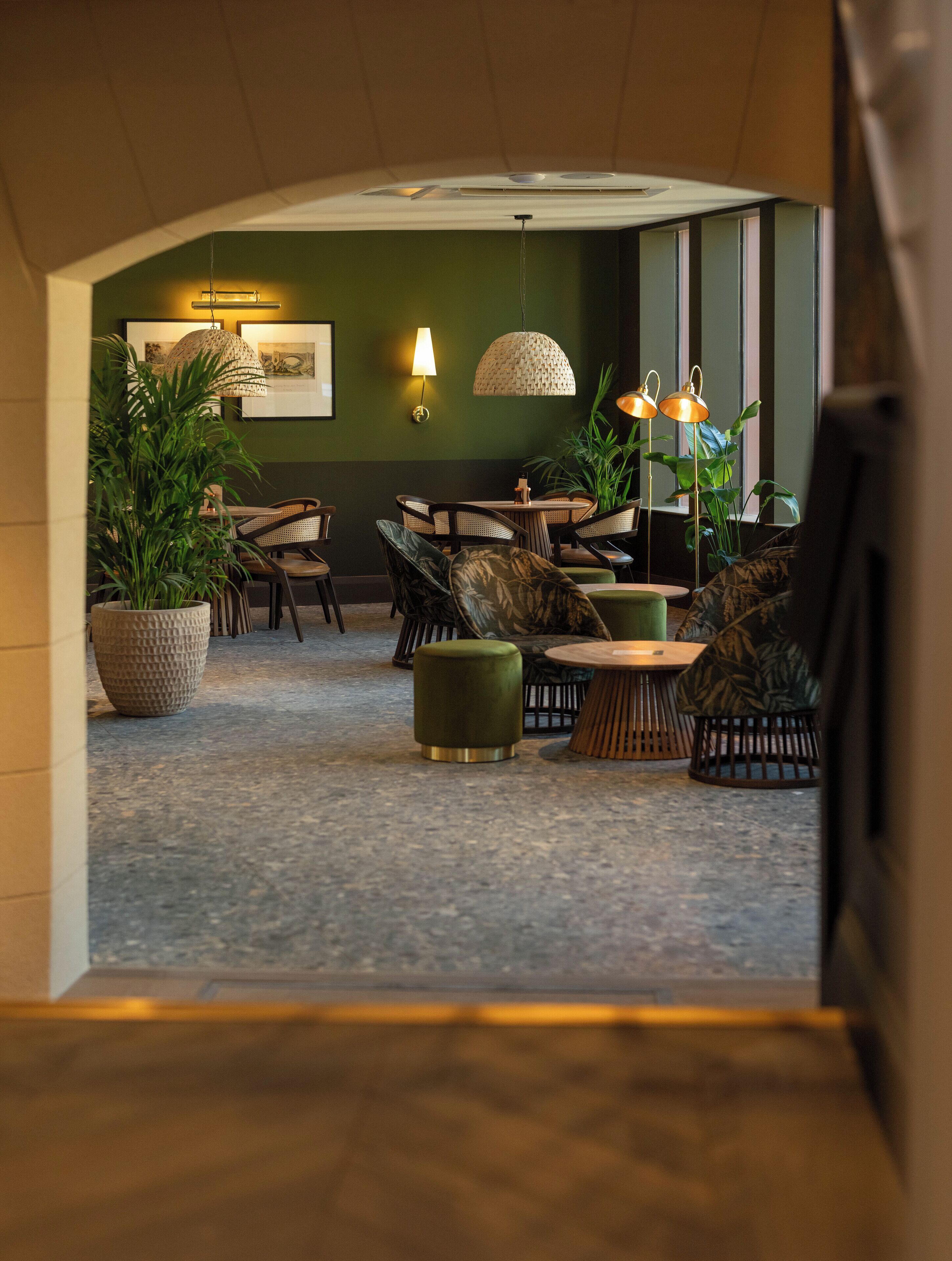A modern lounge area with a round table, comfortable seating, and ambient lighting.