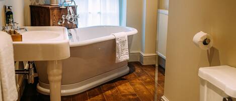 A bathroom with a bathtub, toilet, and sink.