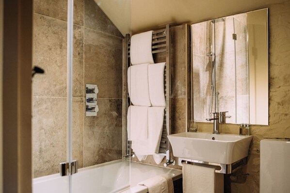 A modern bathroom with a glass-enclosed shower, a sink, and a large mirror. - Assheton Arms (Clitheroe)
