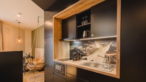 A modern kitchen with a wooden countertop, a built-in sink, and a hanging light fixture. - Rioca Stuttgart Posto 6 (Stuttgart)