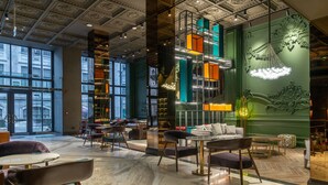 A spacious lobby with high ceilings, large windows, and a mix of seating areas including tables and chairs. - Orient Occident Hotel Istanbul, Autograph Collection (Istanbul)