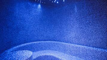 Experience the celestial ambiance in this stylish room, featuring a unique starry ceiling and a cozy seating area.