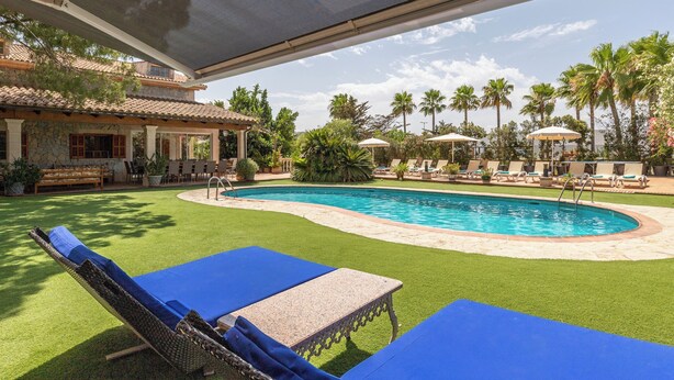 A pool area with lounge chairs, a pergola, and palm trees. - Villa Marjals - Eight Bedroom Villa, Sleeps 16 (Muro)