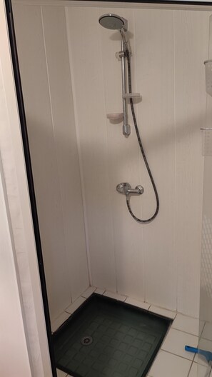 Een douche, een haardroger, handdoeken, toiletpapier