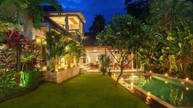 A modern house with a swimming pool, surrounded by lush greenery and well-lit pathways. - 2 BR Tranquil Villa 10 Min Walk to Seminyak Beach (Kuta Utara)