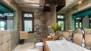 A modern bathroom with a large bathtub, a wooden vanity, and a glass shower enclosure. - 2 BR Tranquil Villa 10 Min Walk to Seminyak Beach (Kuta Utara)