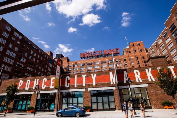 The exterior of the Ponce City Market building with large signage, brick facade, and a clear blue sky.