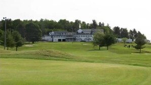 A golf course with a clubhouse in the background. - Elegant Suite with Jacuzzi (Hancock)