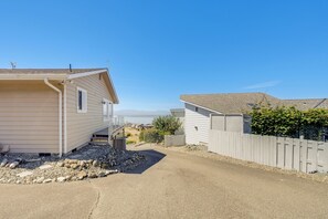 A residential area with houses, a driveway, and a clear sky.