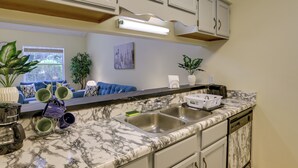 A kitchen with marble countertops, a double sink, and white cabinets. - 4 Mi to Dtwn: Pet-Friendly Abode in Tallahassee! (Tallahassee)